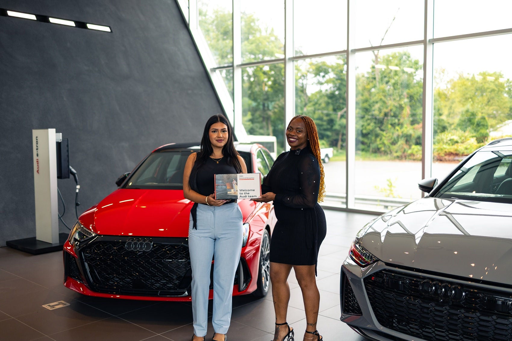 Audi Sale Specialist explaining vehicle features to a customer.