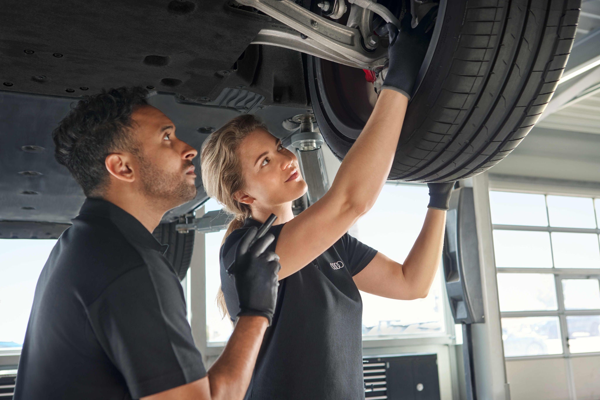 Audi Technician looking under an Audi