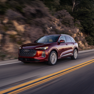 Pre-Owned Specials. Side view of an Audi vehicle driving.