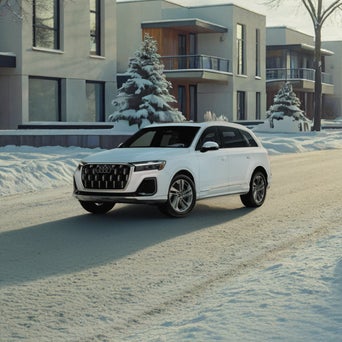Audi Q7 equipped with winter tires parked on a snow-covered road