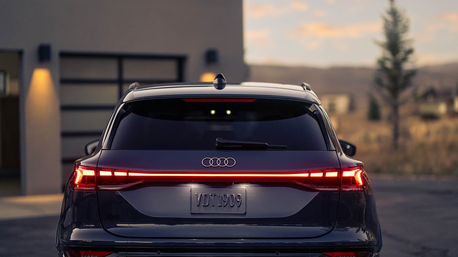 Rear profile view of an Audi Q6 parked.