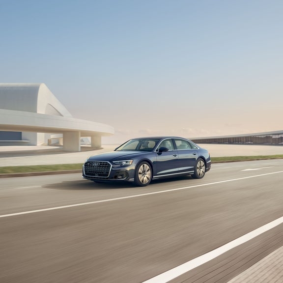 Three quarter front profile of the Audi A8 accelerating.