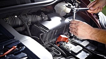 Service technician servicing vehicle.