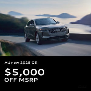 Side view of an Audi Q5 driving.