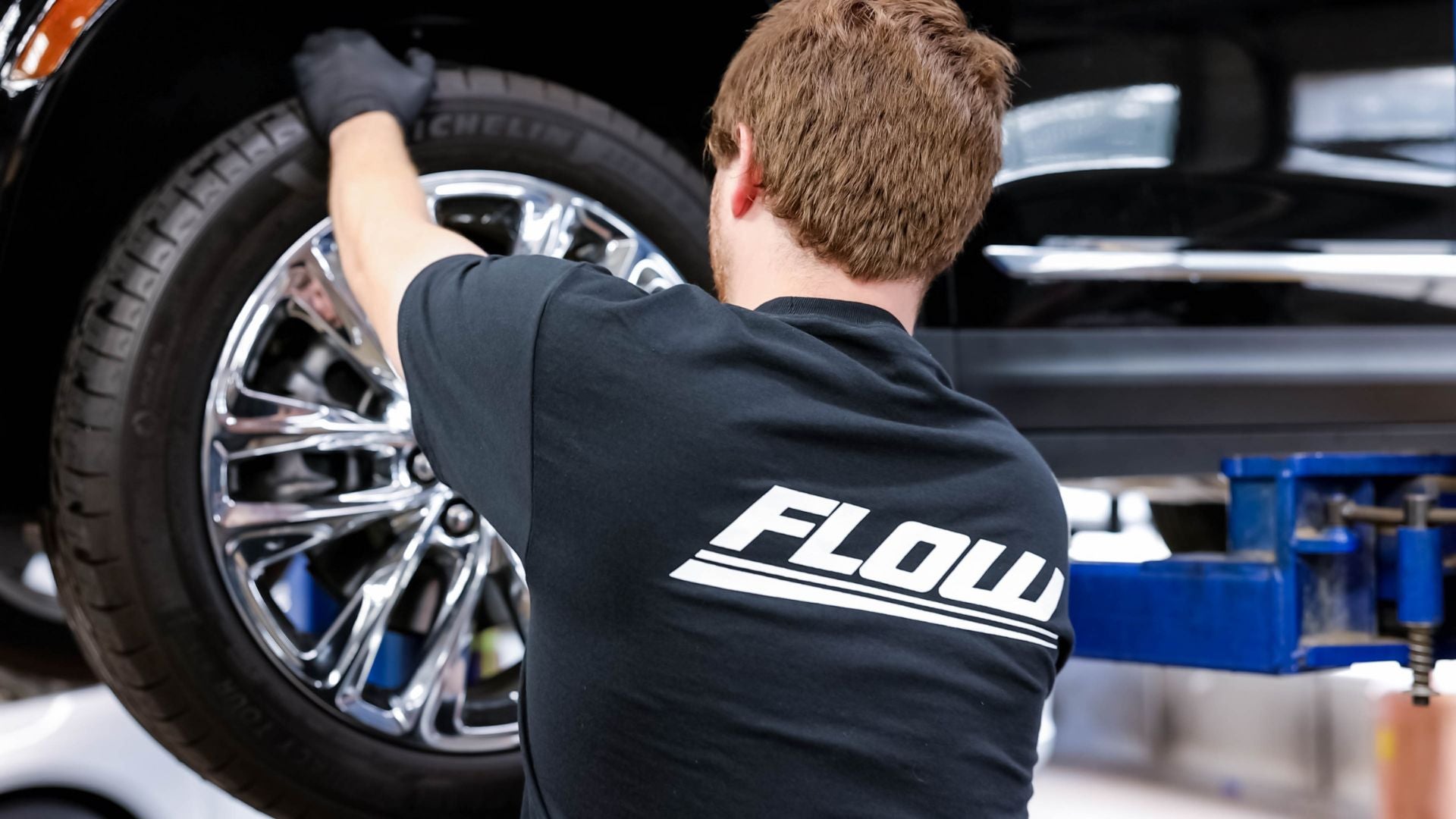 Audi service technician servicing a vehicle.