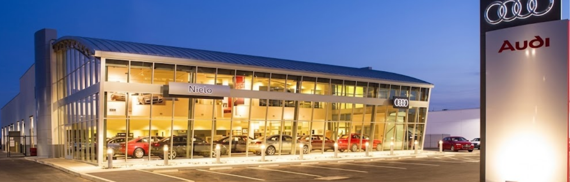 Audi Sale Specialist walking through the showroom with a couple.