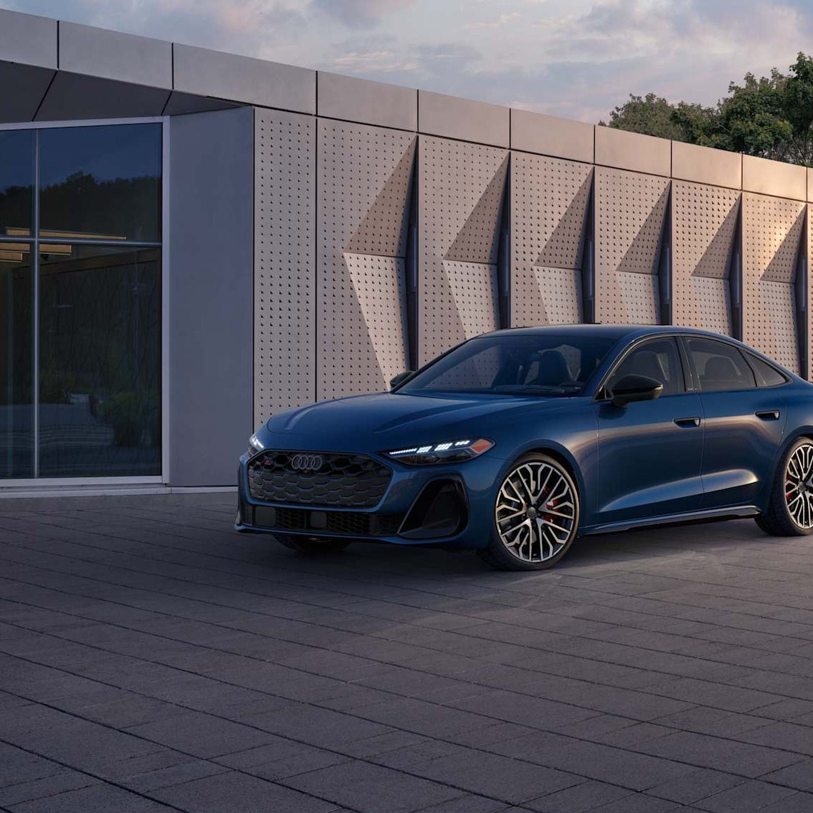 2026 Audi S5 in Ascari Blue, rear three-quarter view.