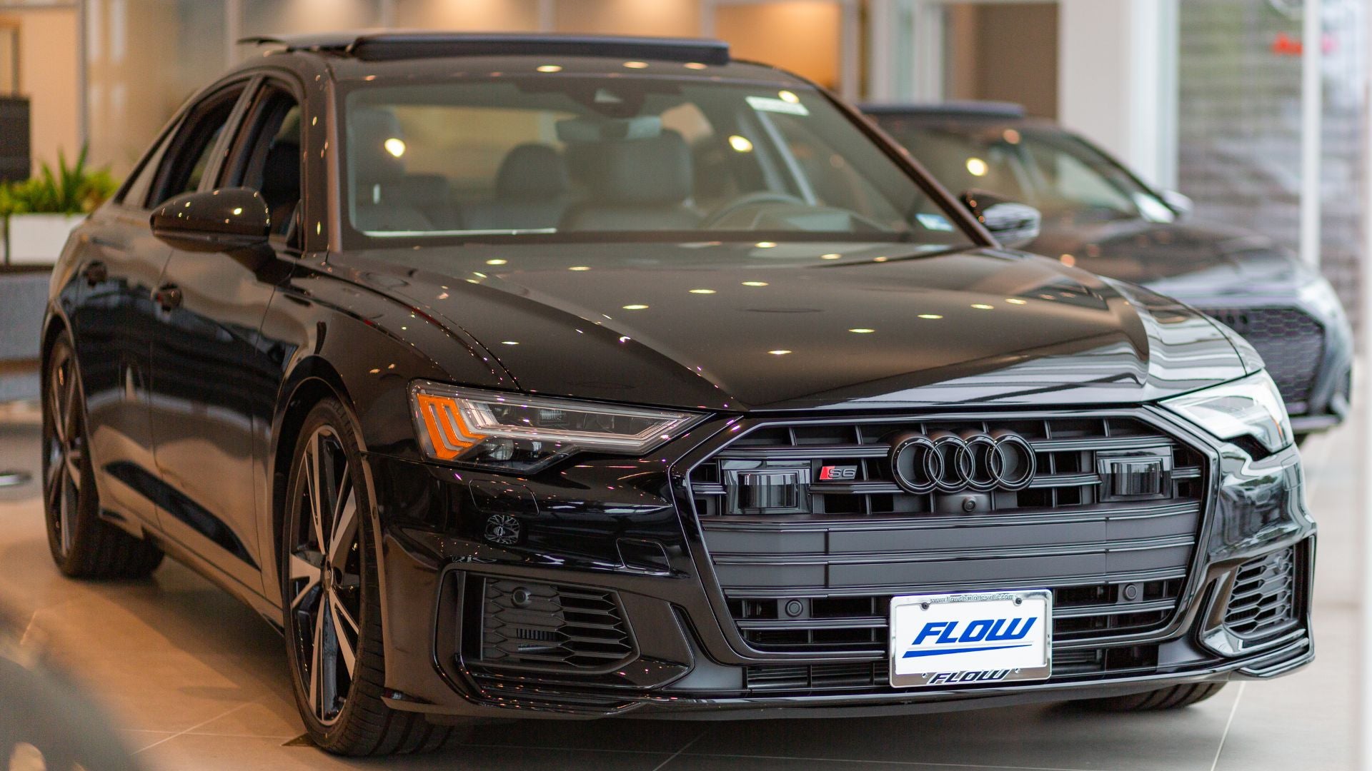 The front of an Audi sedan parked inside the Audi Charlottesville showroom