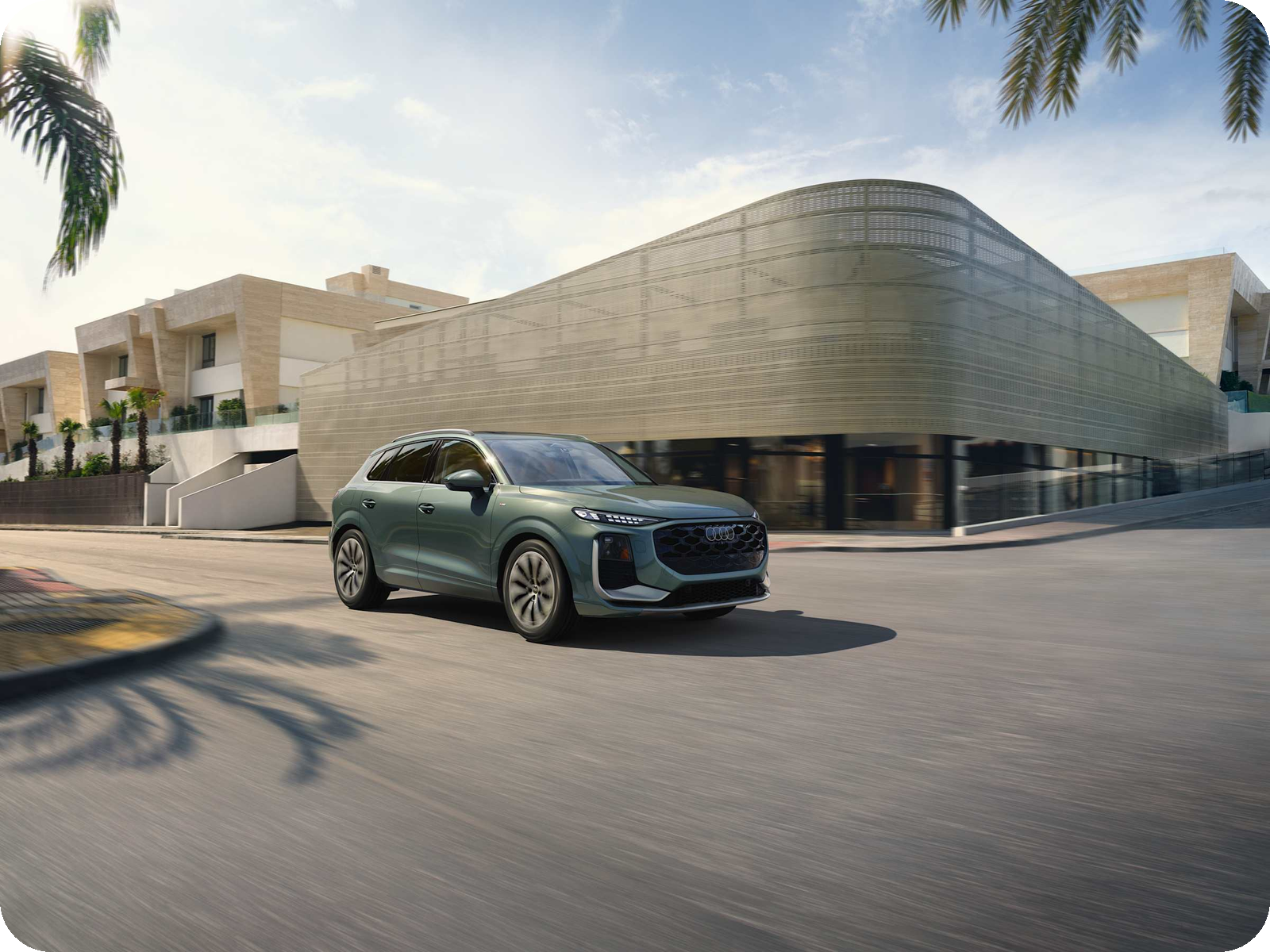 2026 Audi Q3 driving — compact luxury SUV.