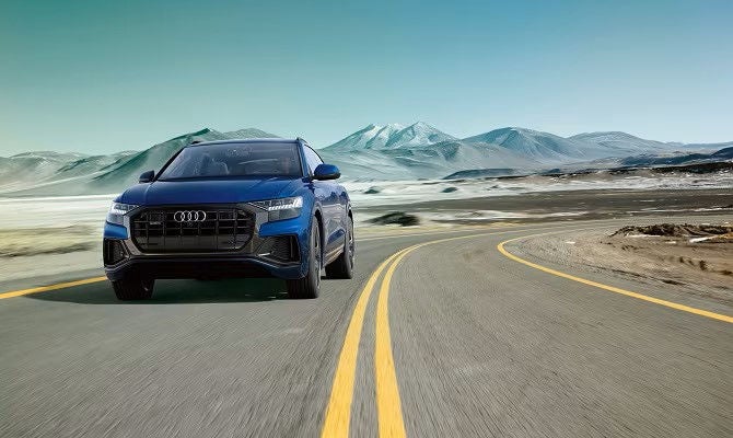 Front view of Audi Q8 driving on highway