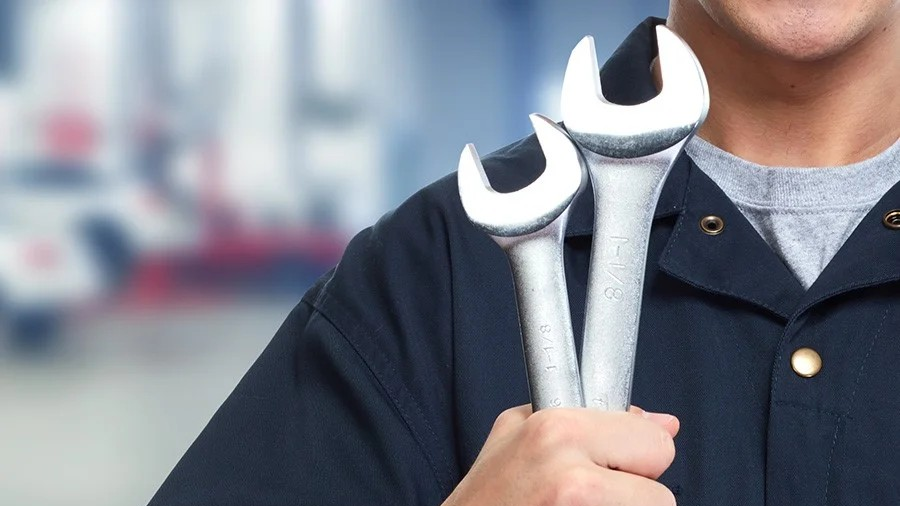 Audi service technician servicing a vehicle.