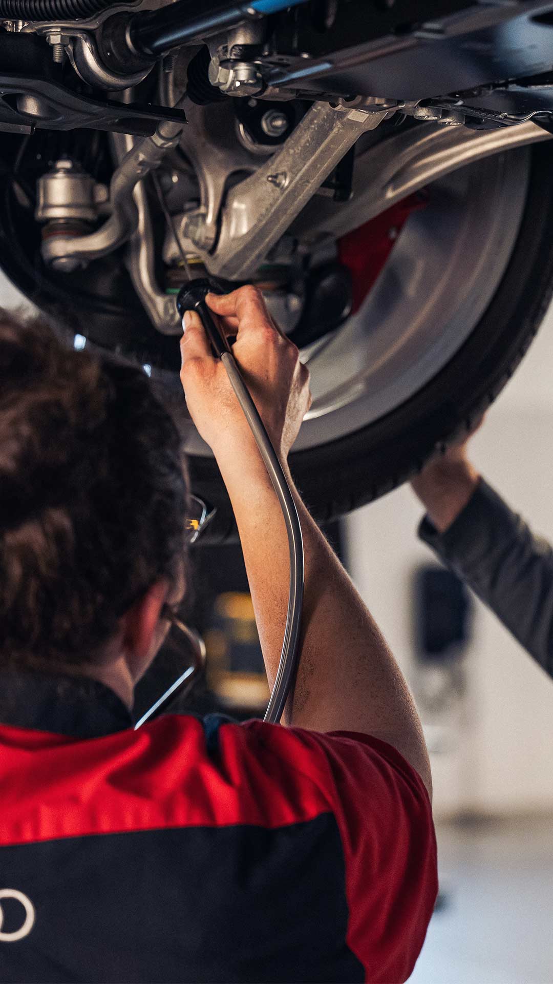 Service technician servicing vehicle.