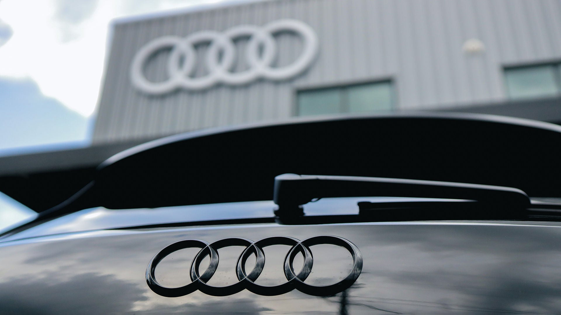 Audi Sale Specialist explaining vehicle features to a customer.