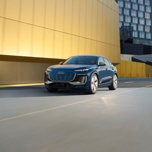 Three-quarter view of the Audi SQ6 Sportback e-tron accelerating.