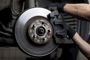 Service technician servicing brake.
