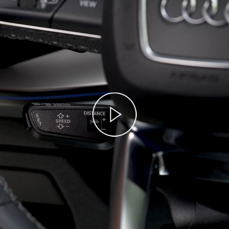 Close up on the cruise control stalk inside an Audi vehicle. 