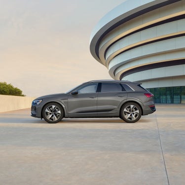Side profile of a gray Audi Q8 e-tron parked.