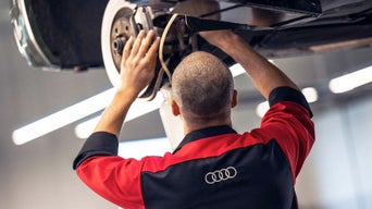 A technician working on brakes.