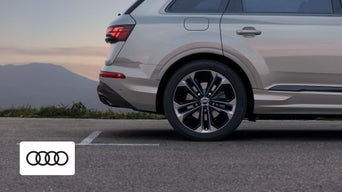 A sleek Audi Q7 parked outside the Audi Dayton dealership, showcasing its refined exterior styling
