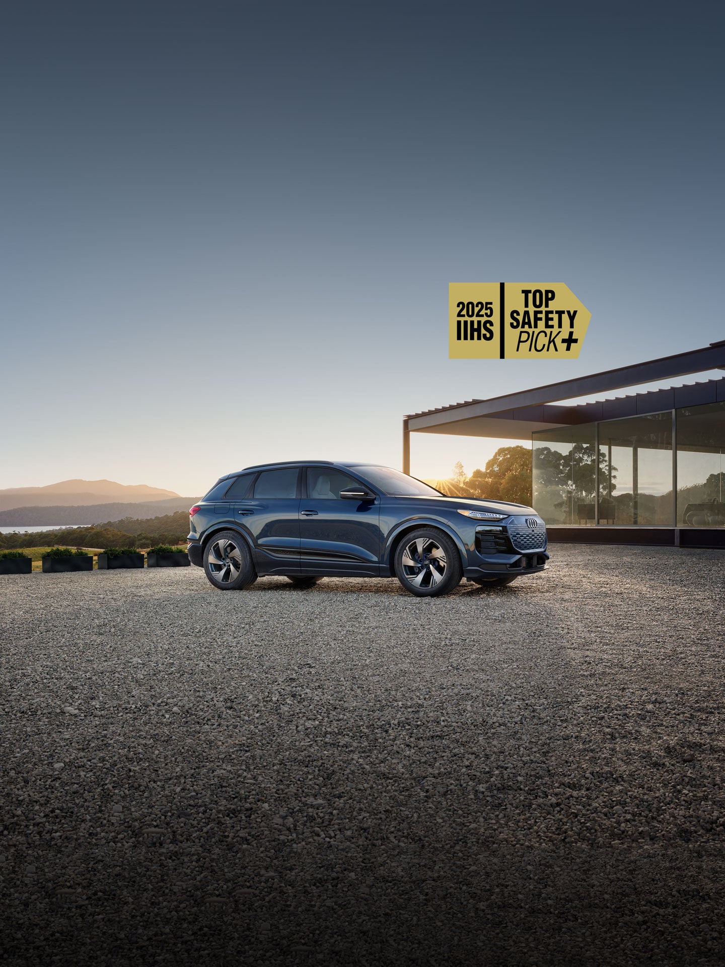 Three-quarter side view of the Audi Q6 e-tron parked.