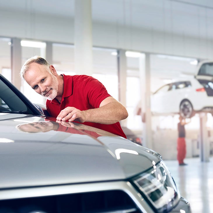 Audi employee completing a 300+ point inspection. 