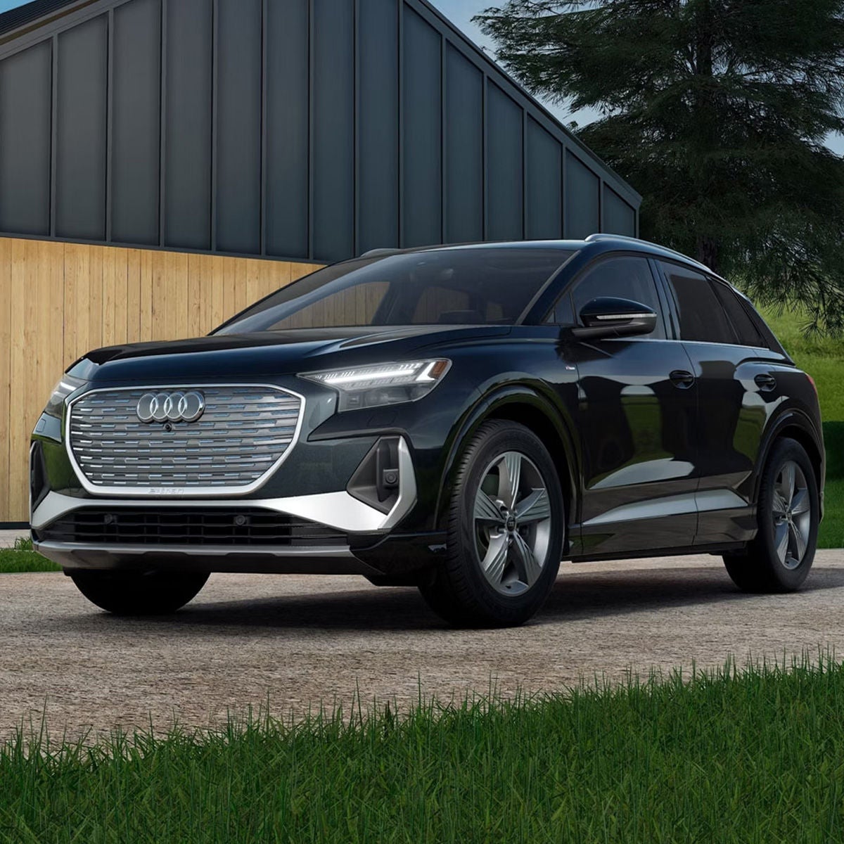 Three-quarter front view of the Audi Q4 e-tron parked in a forest.