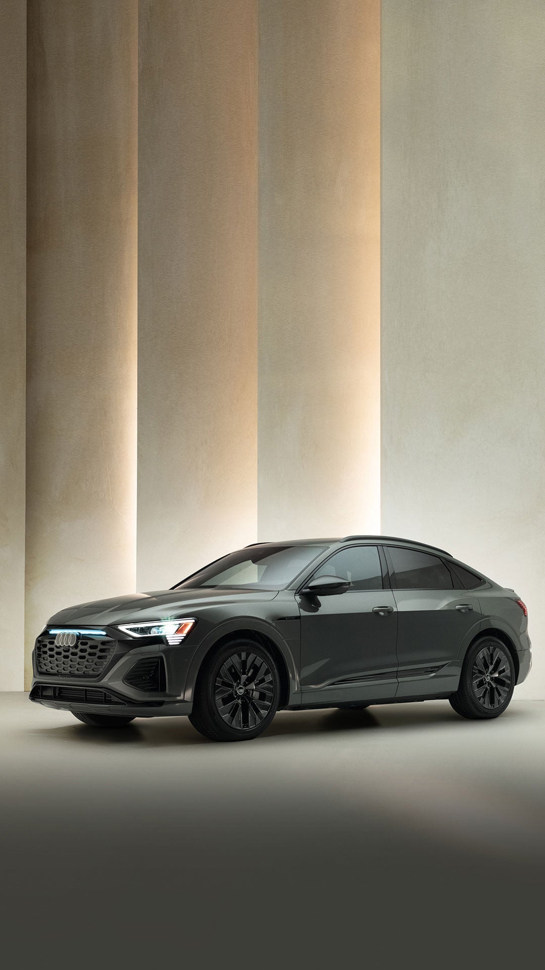 Three-quarter front view of a dark grey Audi Q8 e-tron. 