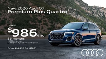 Side view of an Audi Q7 parked.