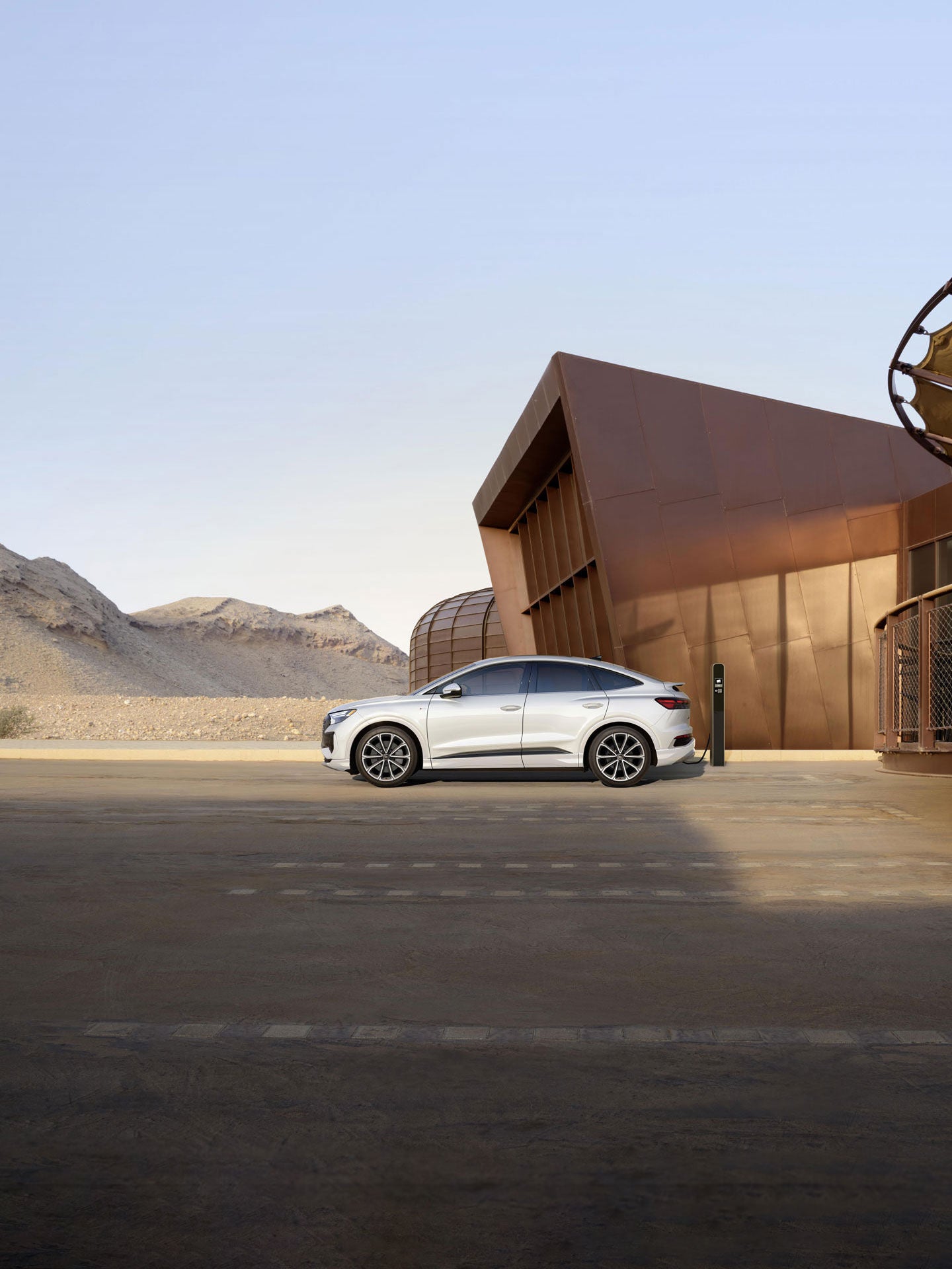 Side view of the Audi Q4 Sportback e-tron charging.