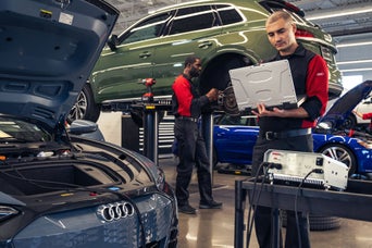 Technicians consulting Audi Multipoint Inspection