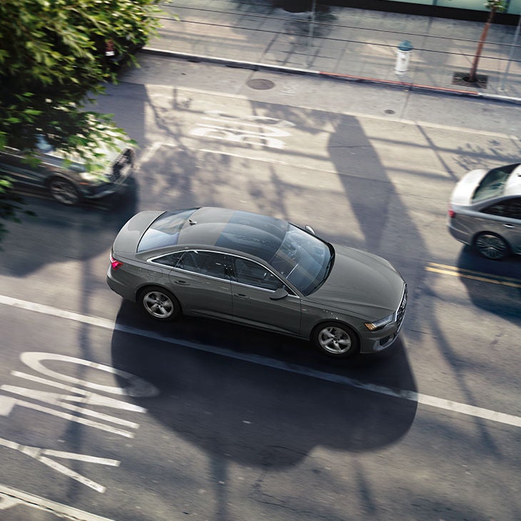 Bird’s eye view of an Audi A6 Sedan accelerating down the road.