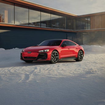Audi e-tron GT equipped with winter tires parked on a snow-covered road