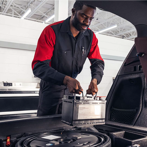 technician replacing a battery