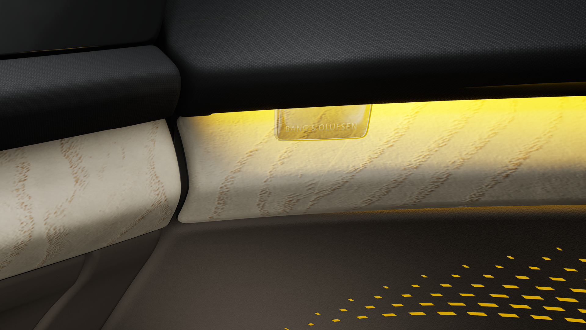 Close-up of the Bang & Olufsen logo, illuminated by the yellowish interactive light.