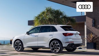 Coupe-style Audi SUV lineup displayed outside the Audi Dayton dealership on Springboro Pike.