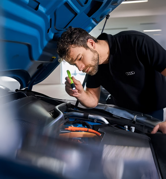 Audi technician servicing a vehicle 