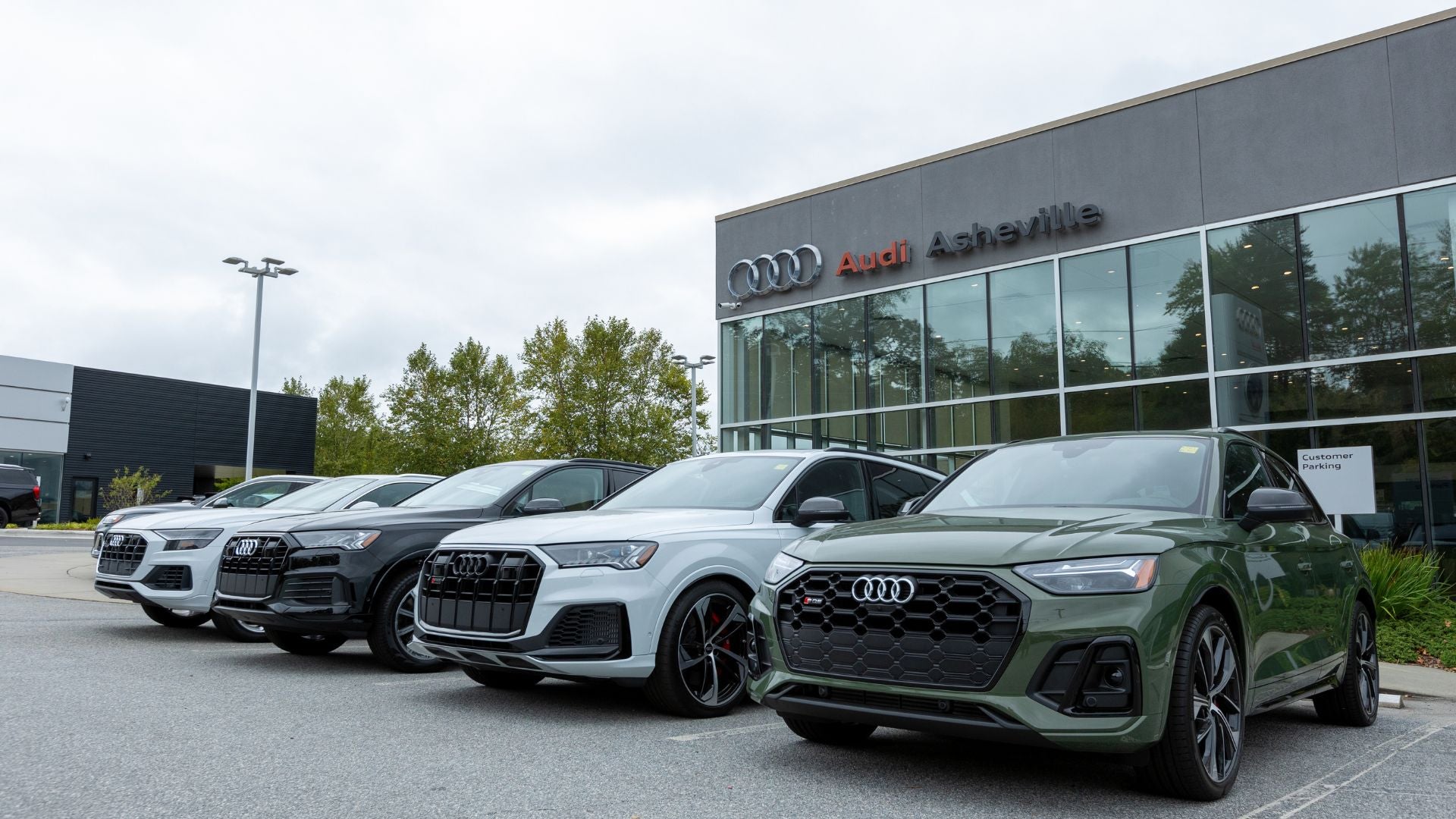 Lineup of Audi cars for sale parked outside the Audi Asheville dealership