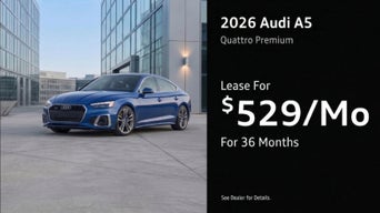 Three quarter view of an Audi A5 driving.