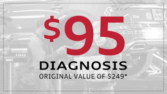 Service technician servicing vehicle. 