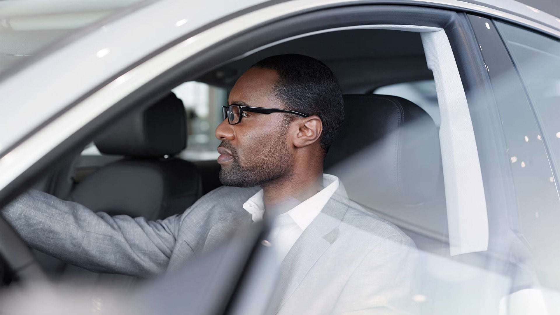 A man sitting in an Audi