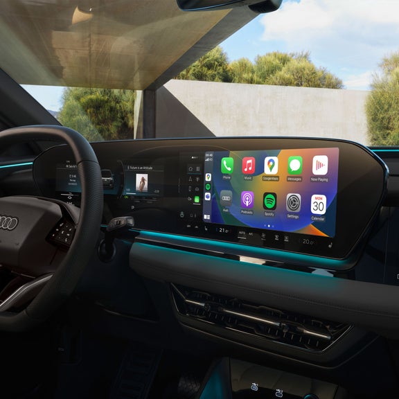 Close-up on the interior driver and passenger displays in the Audi Q6 e-tron, showing the smartphone connectivity feature.
