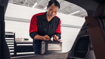 Service technician installing battery.