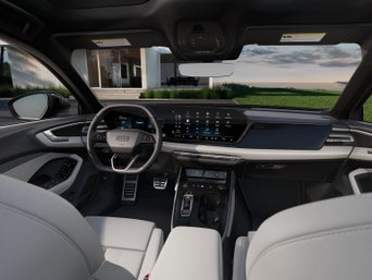 Vue de l’habitacle d’un Audi A5 montrant le tableau de bord et le volant.