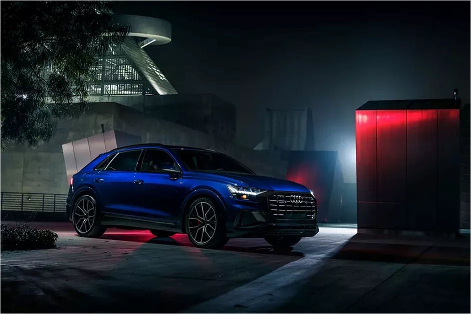 Right side profile view of an Audi Q8 SUV parked.