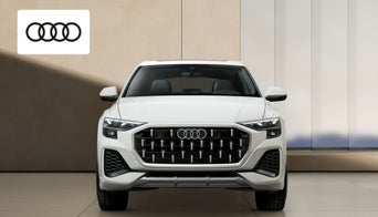 Close-up of Audi Q8 interior showing advanced infotainment system and luxurious seating. 