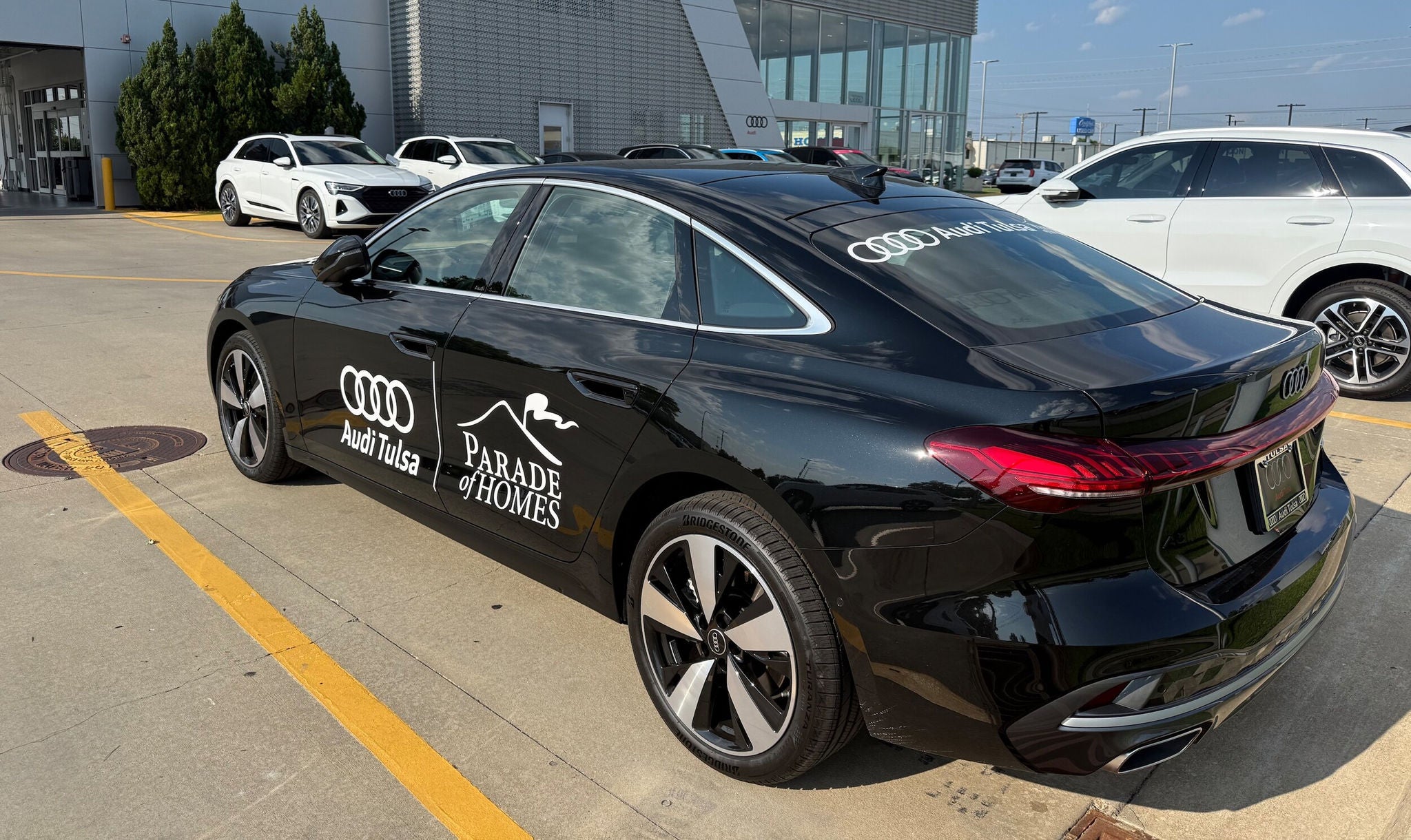 Right side profile view of an Audi parked.