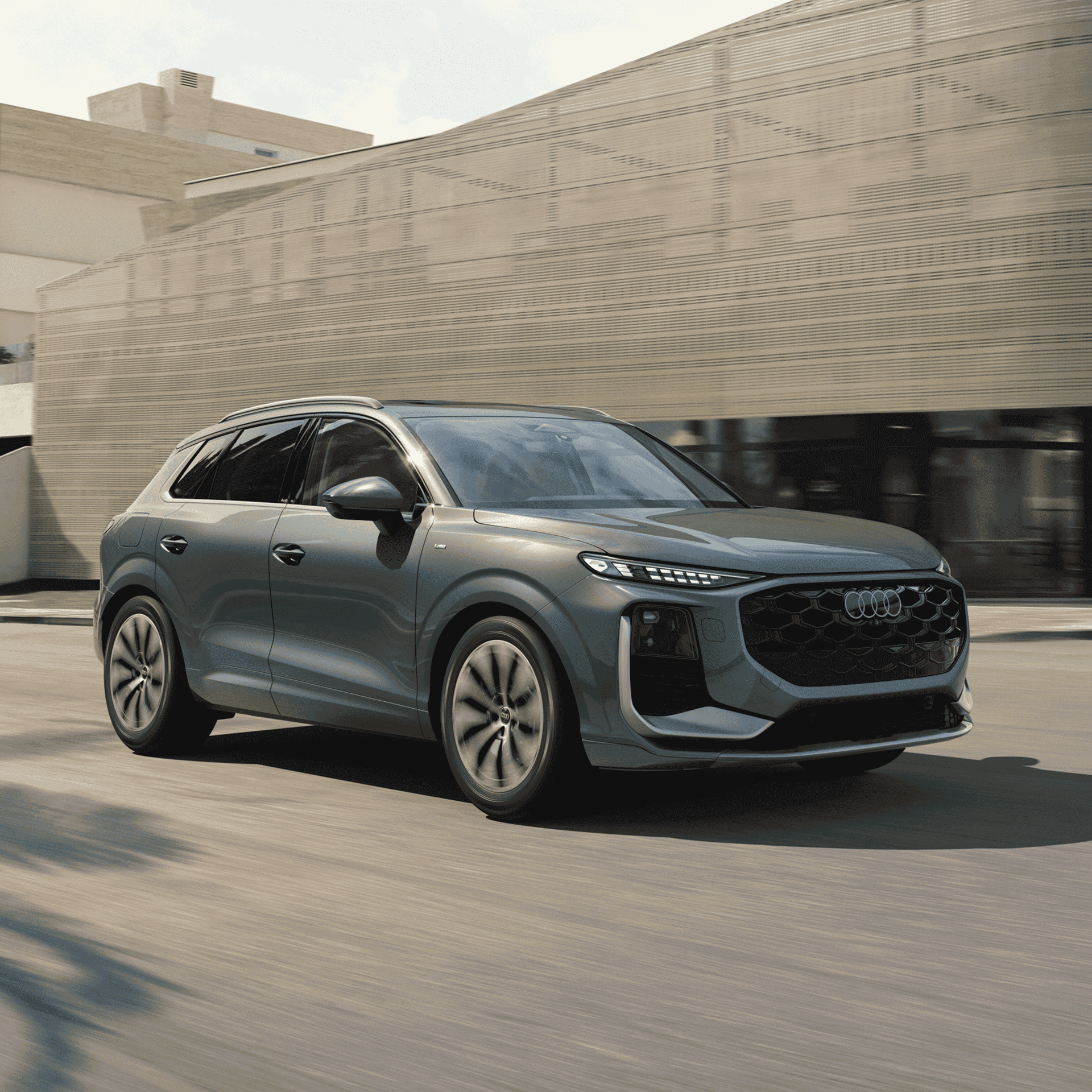 Side profile view of an Audi Q3 accelerating.