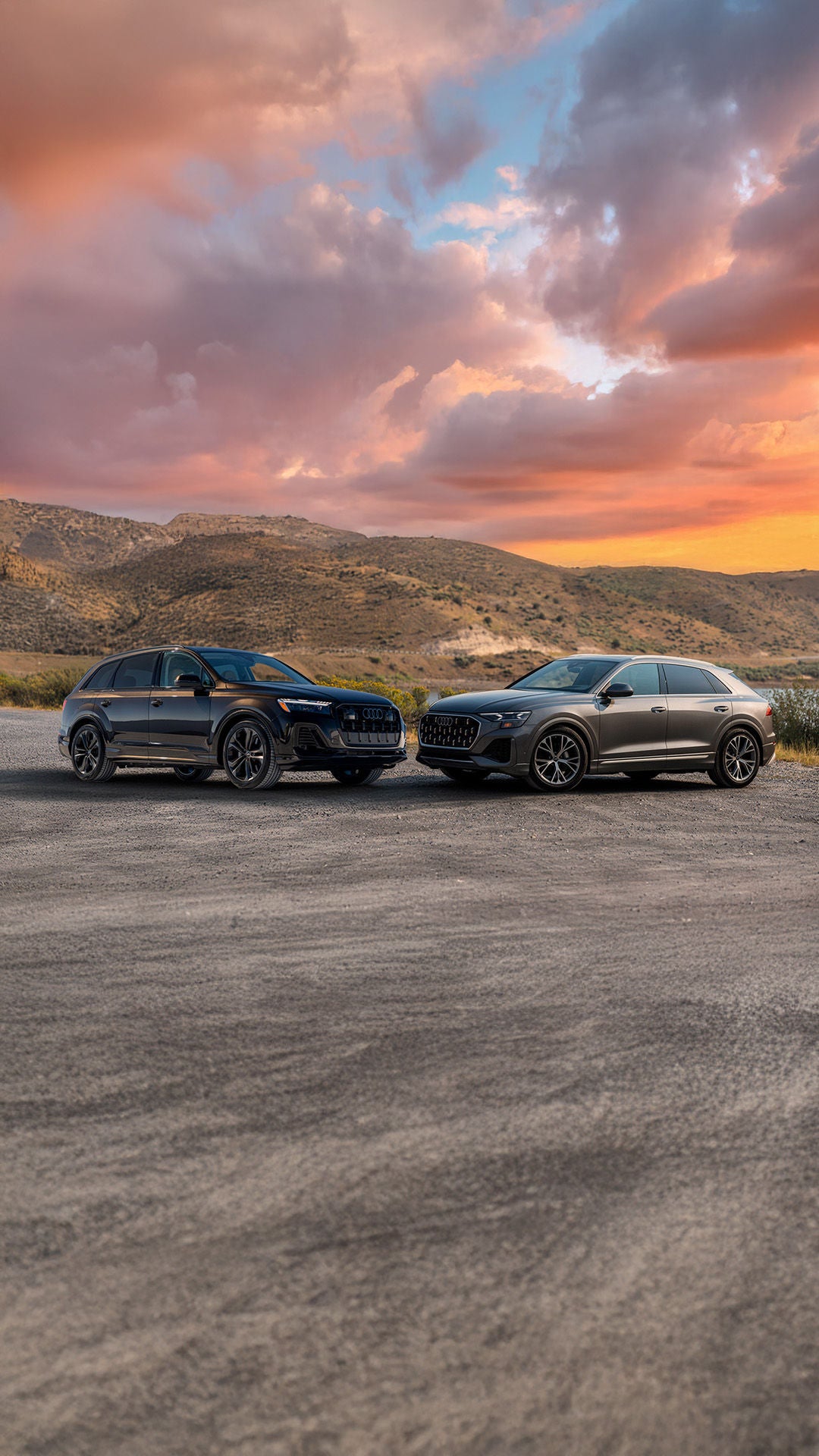 2026 Audi Q7 vs Q8 parked head to head under a mountain sunset