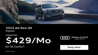 Three quarter view of an Audi Q5 driving.