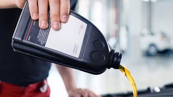 Service tech filling oil tank.